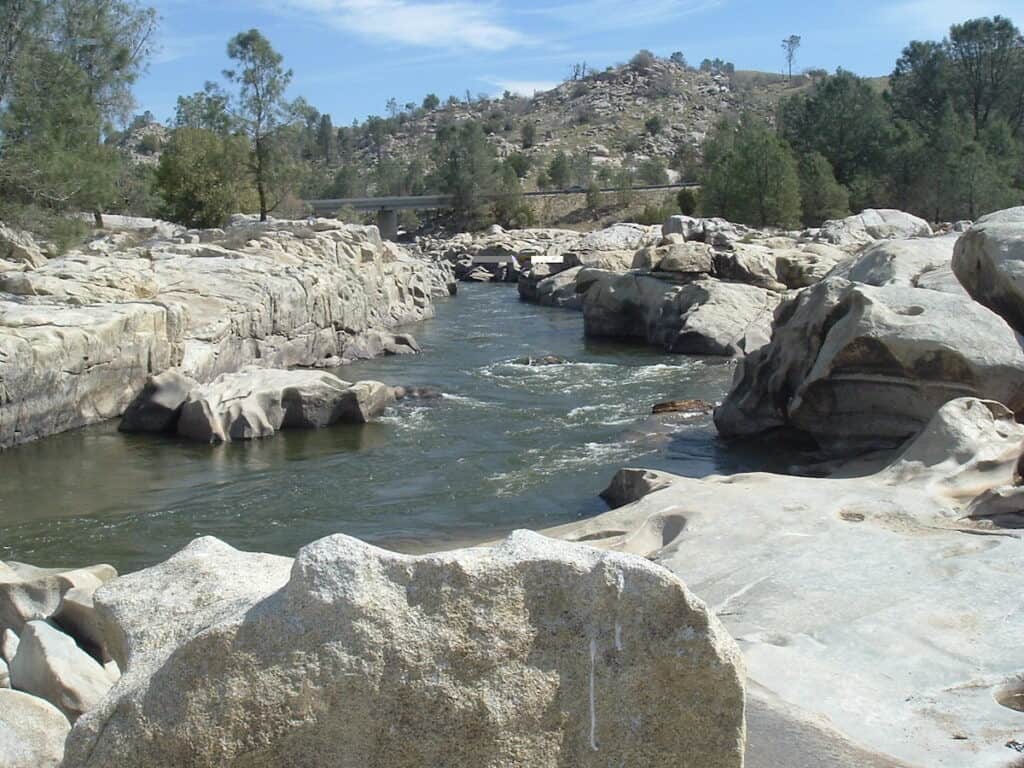 Kern River flowing through a notch of sun-bleached rocks in the Keysville Special Recreation Area on the lower river.