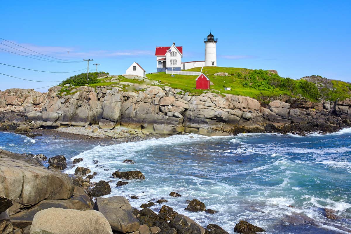 The Nubble Lighthouse sits on an island just off the Maine coastline, with a channel shown in front popular for striper fishing.