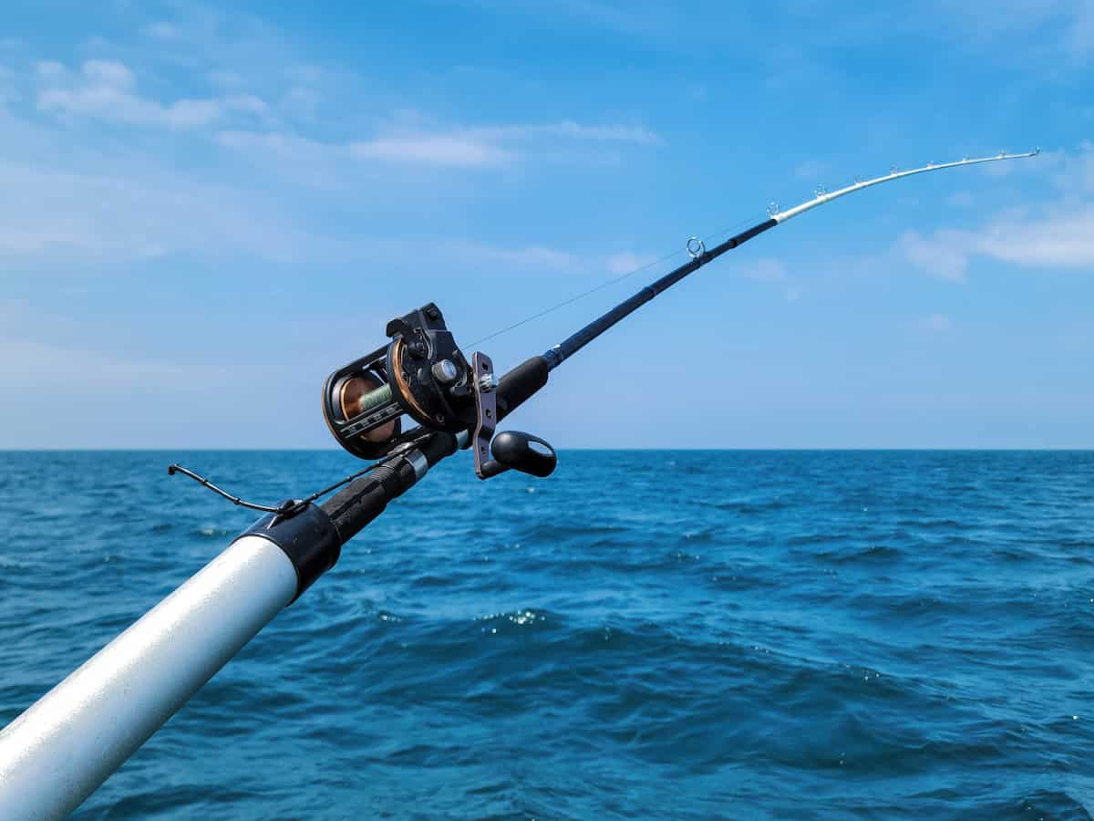 A large fishing rods bends while trolling the depths of Lake Michigan, a style of fishing associated with catching salmon in deep water.