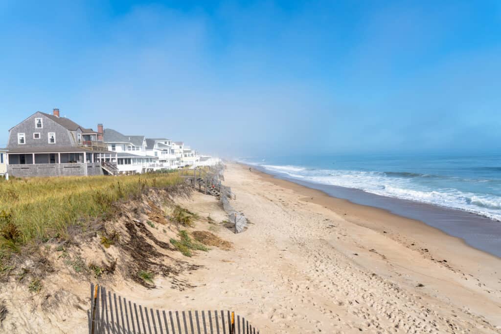 View of a sandy Seabrook Beach along the coast of New Hampshire on a misty autumn morning.