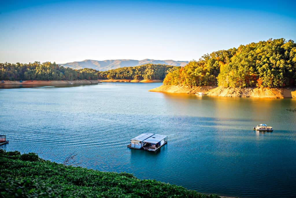 Fontana Lake fishing boat with exposed shorelines in low water, a popular fishing lake in the Great Smoky Mountains of North Carolina.