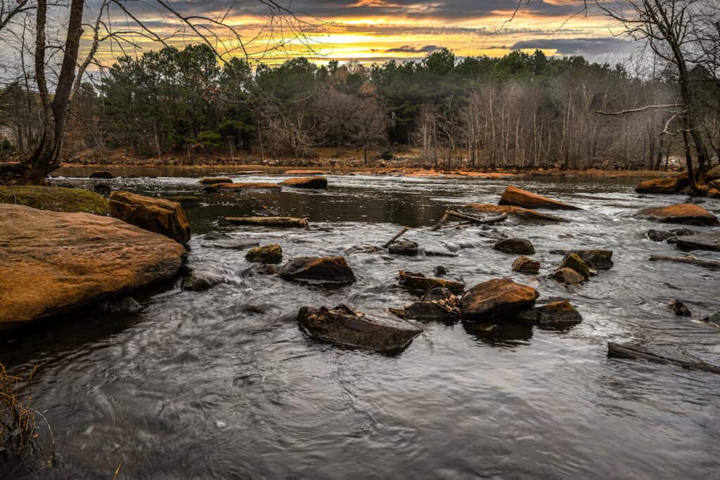 Along the banks of the Neuse River in Raleigh, NC, where smallmouth bass fishing is very good.