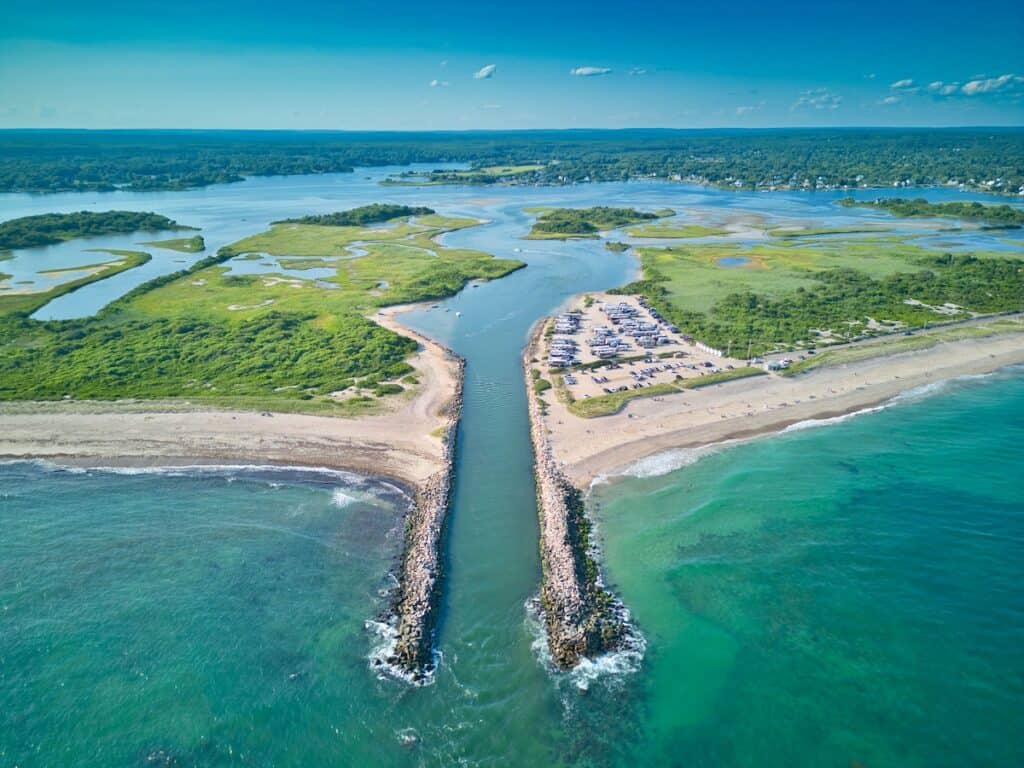 Aerial photo of the Charlestown Breachway connecting to Block Island Sound in Rhode Island through jetties in the foreground.