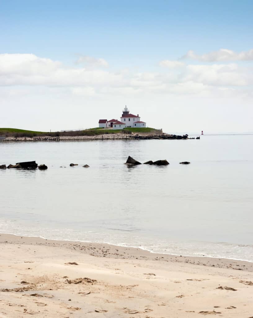 Watch Hill, Rhode Island beach with the historic lighthouse landmark in the distance.