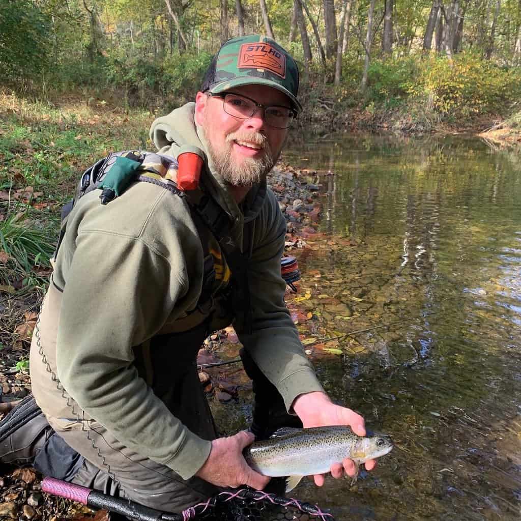 Maryland fishing guide John Peake holds a rainbow trout he caught fly fishing in the Savage River.