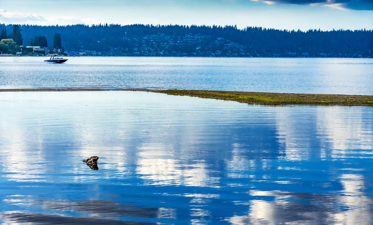 A fishing boat on the reflective surface of Lake Sammamish at the state park.