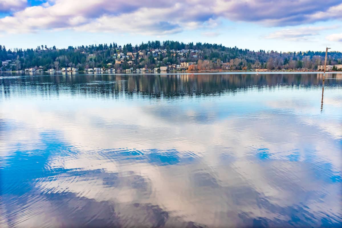 Reflections of clouds on a still Lake Washington at Kirkland's Juanita Bay Park.