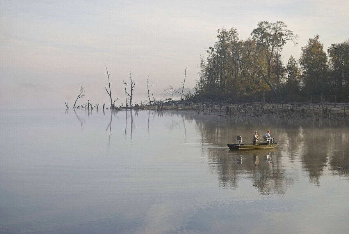 A fishing boat in the early morning on Manasquan Reservoir, one of New Jersey's best bass fishing lakes.